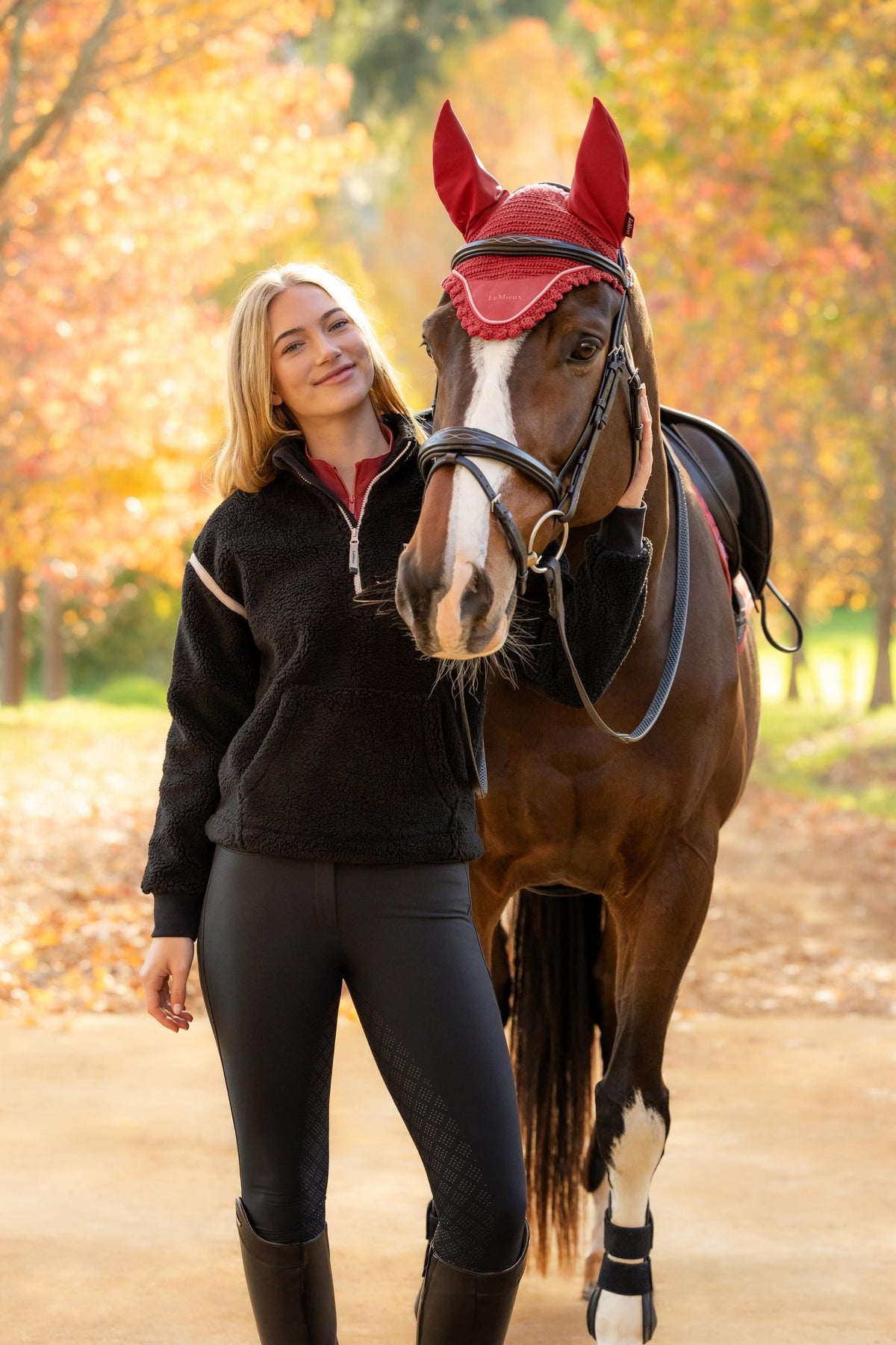 LeMieux Avery Teddy Quarter Zip Fleece Black: Woman with horse in autumn, cozy equestrian wear