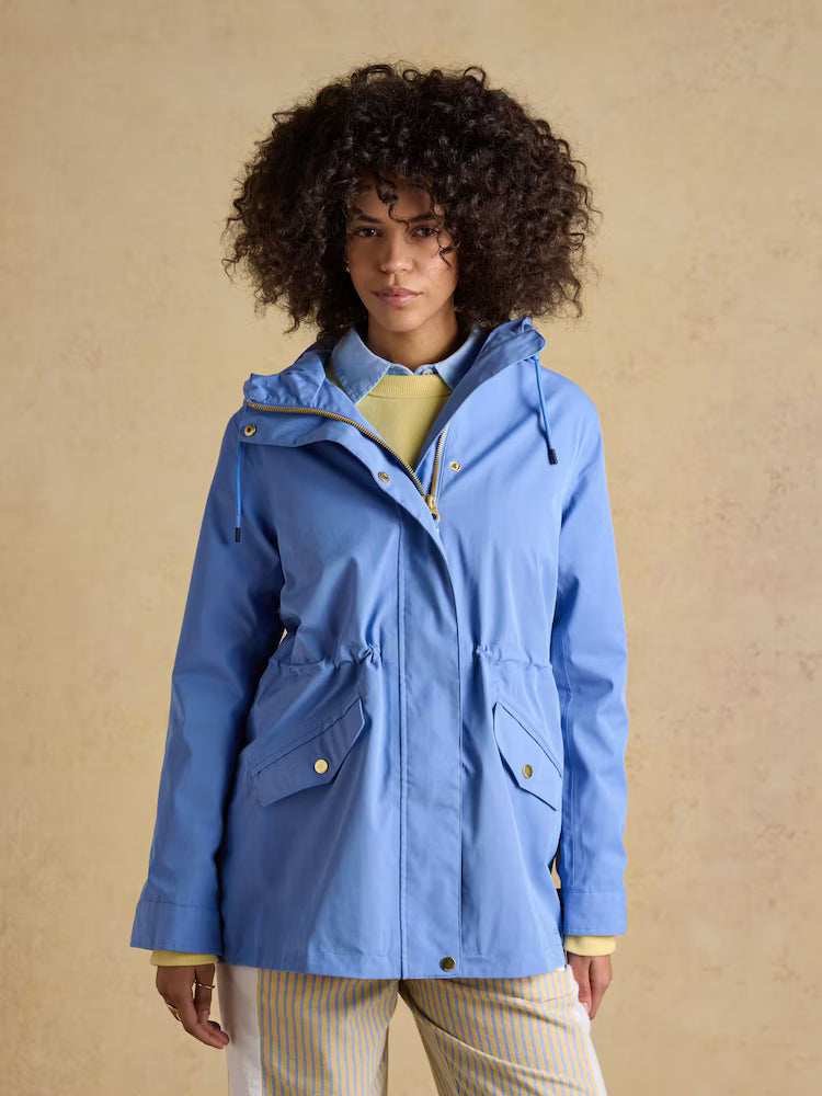 Joules Portwell blue hooded waterproof raincoat for women with adjustable waist and pockets.