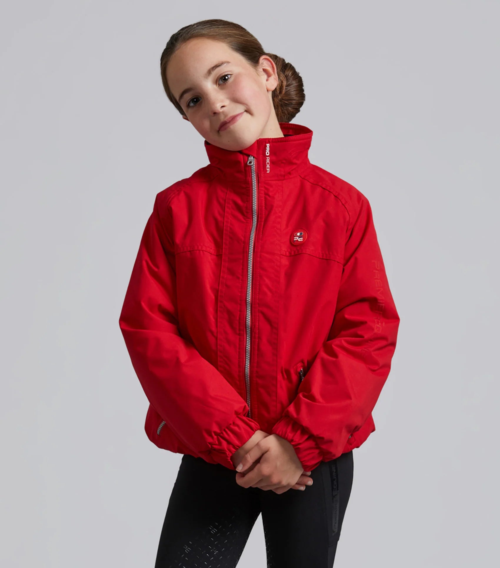 Girl in Red Riding Jacket | PREMIER EQUINE Junior Equestrian Jacket | Waterproof Riding Apparel