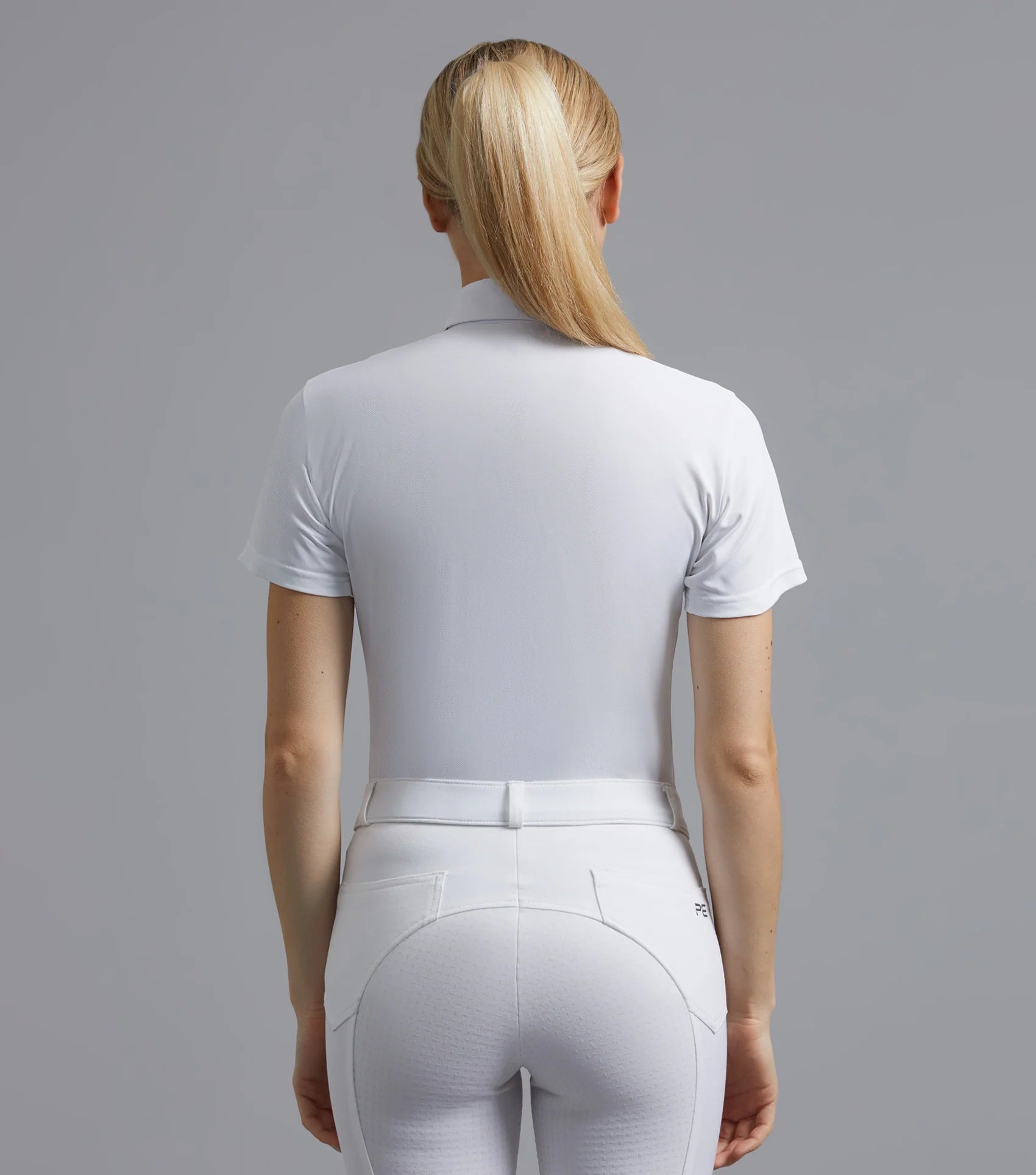 Premier Equine White Short Sleeve Riding Shirt & Breeches. Women's Equestrian Apparel. Back view.
