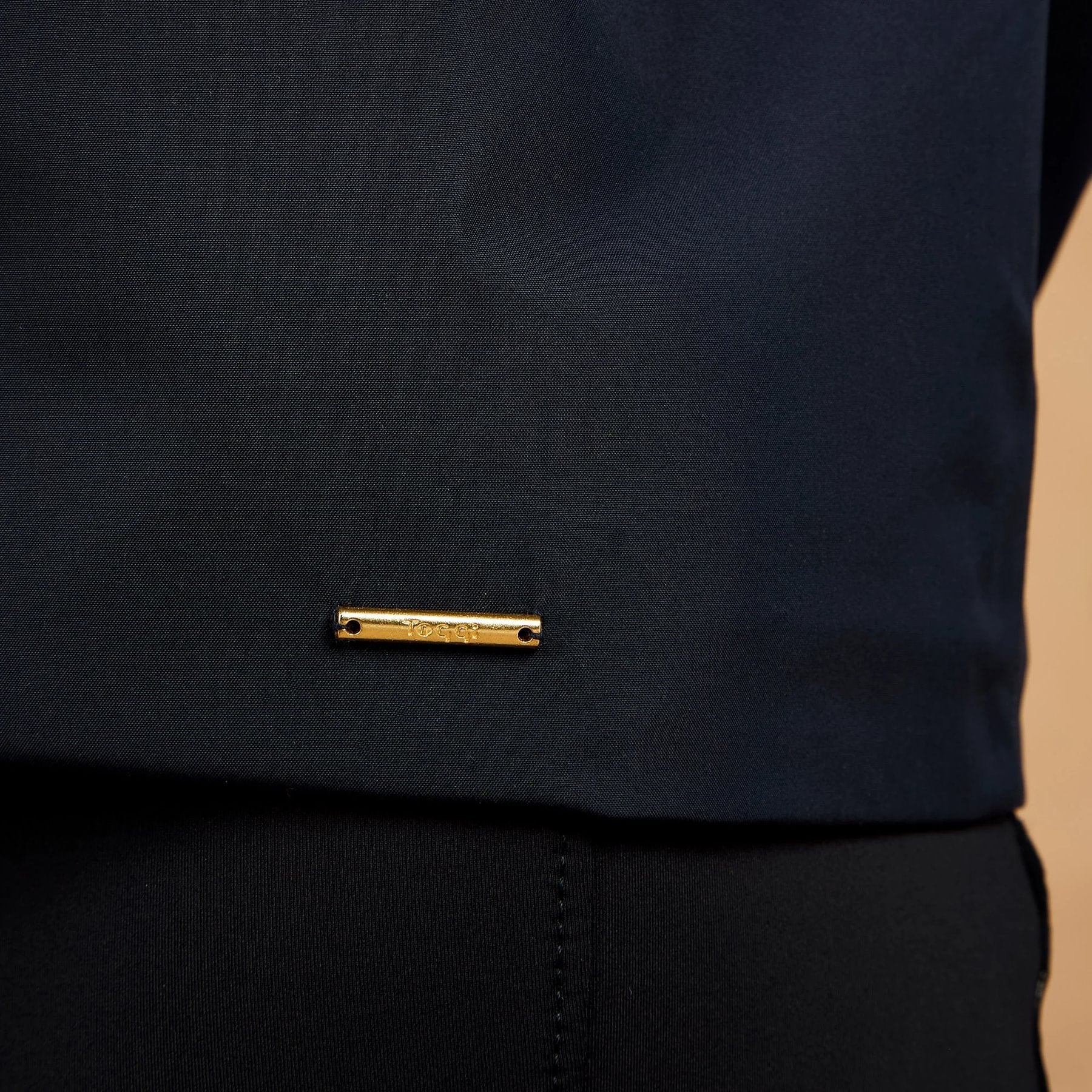 TOGGI Meyer women's navy blue waterproof blouson jacket with gold logo detail.
