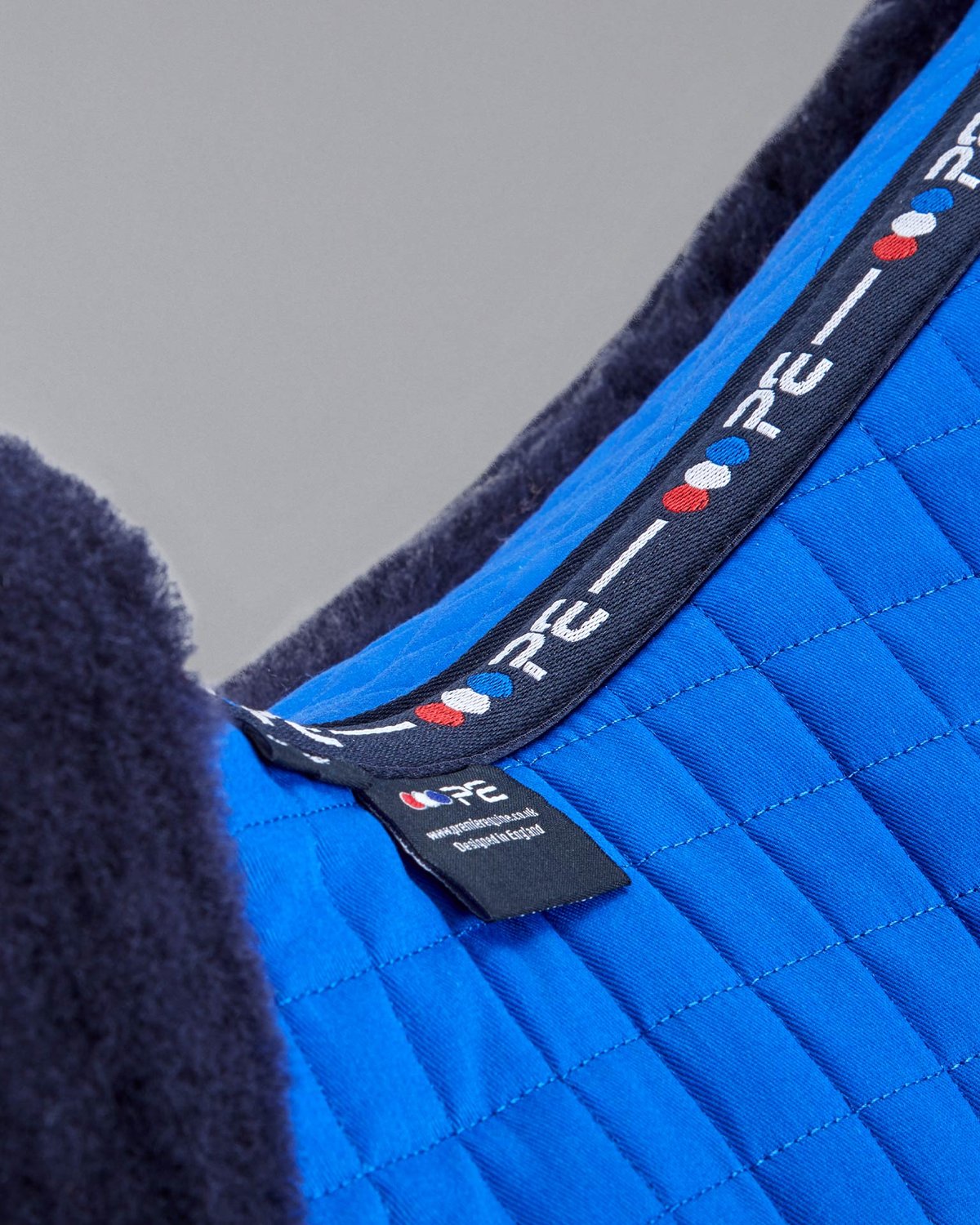 Premier Equine Merino Wool Royal Blue Saddle Pad: GP/Jump Numnah Close-up. Luxurious & Comfortable Horse Riding Equipment.