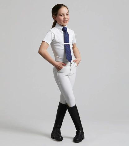 Girl in white riding show shirt, tie, and black boots. Premier Equine Luciana Short Sleeve Shirt. Equestrian Apparel.
