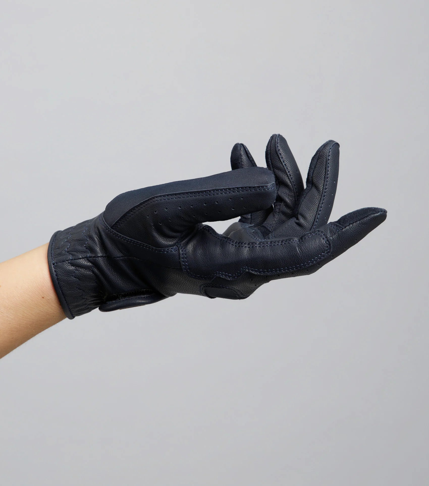 Premier Equine Mizar ladies navy leather riding glove on hand, Equiflair equestrian apparel. Soft, breathable, and excellent grip.