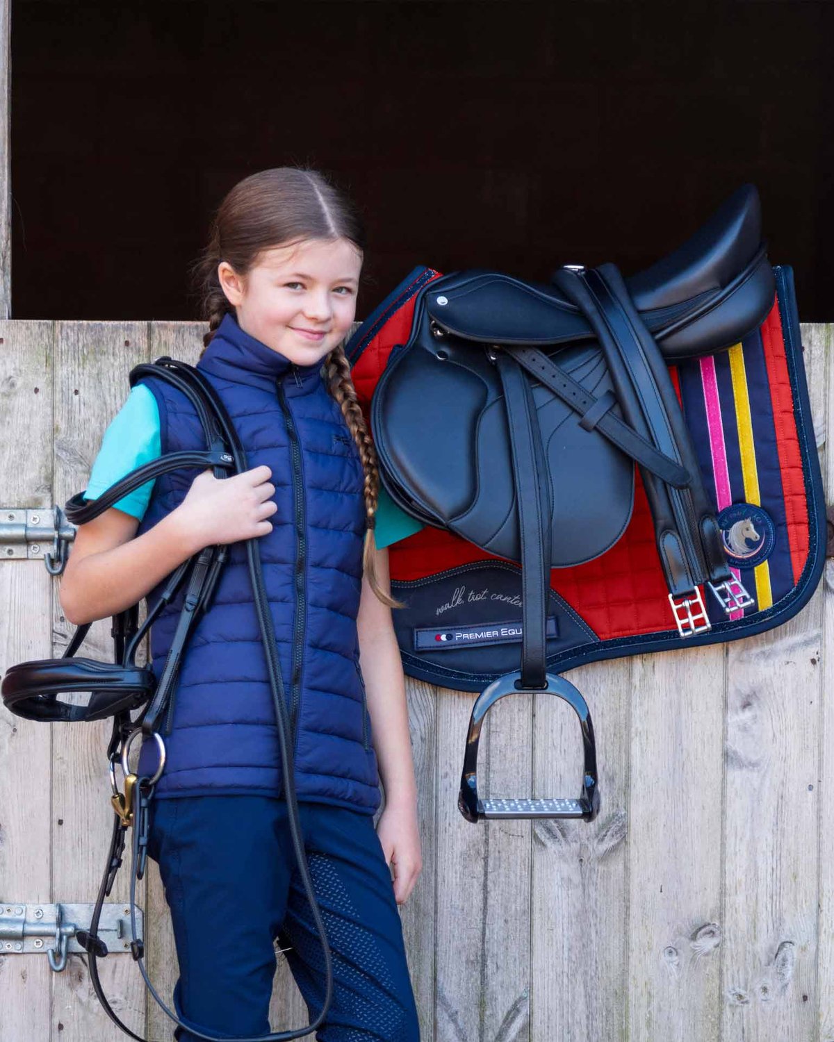 Young equestrian with Premier Equine saddle & My Pony Jack saddle pad & bridle. Riding gear for kids.
