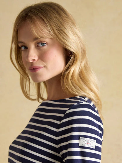 Joules Harbour Top Navy/White Breton Shirt. Woman in striped Joules shirt, relaxed fit boat neck from Equiflair