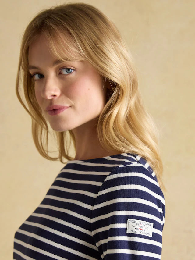 Joules Harbour Top Navy/White Breton Shirt. Woman in striped Joules shirt, relaxed fit boat neck from Equiflair