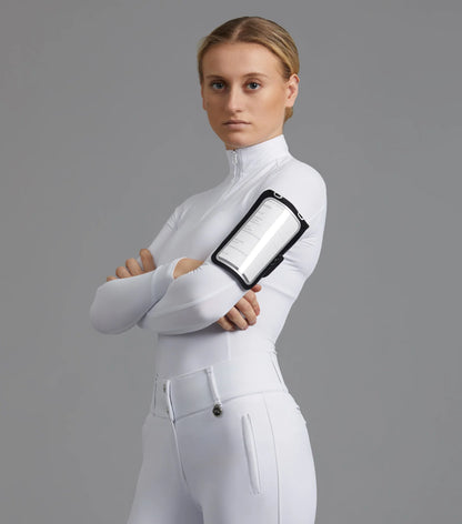 Equestrian woman in white with medical armband - PREMIER EQUINE safety gear. - location-109746323830-instock…