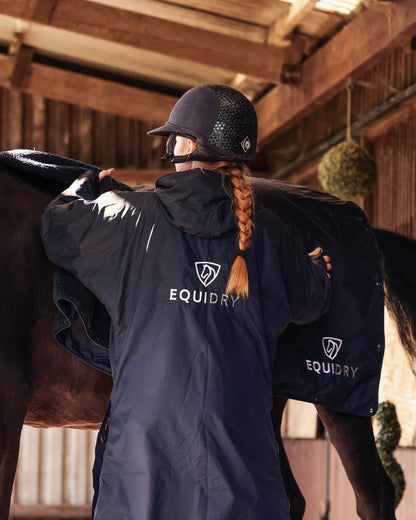 EQUIDRY women's long waterproof horse riding coat in Dark Navy/Navy showing horse with matching equiblanket