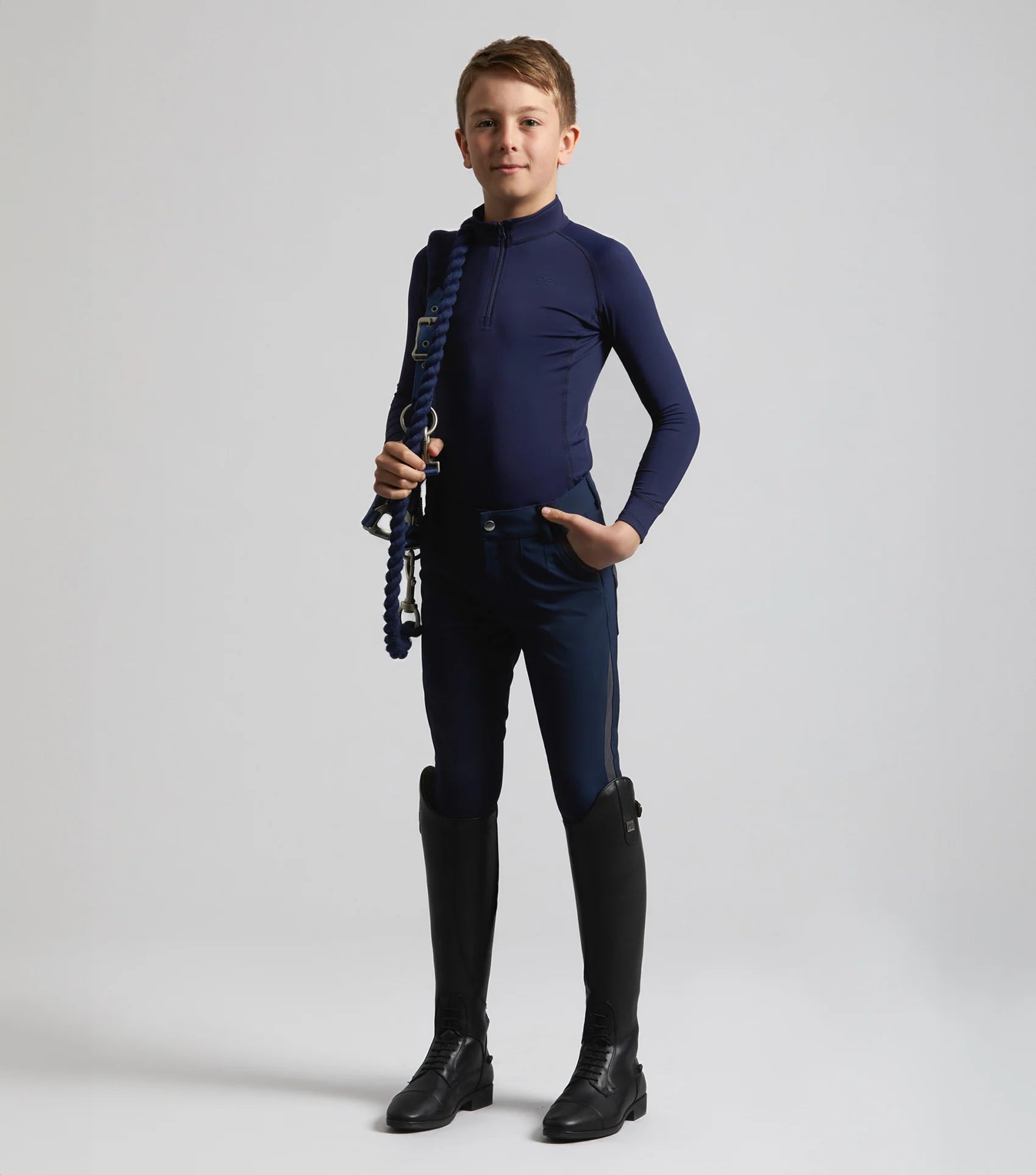 Junior Equestrian Rider in PREMIER EQUINE Navy Technical Riding Top