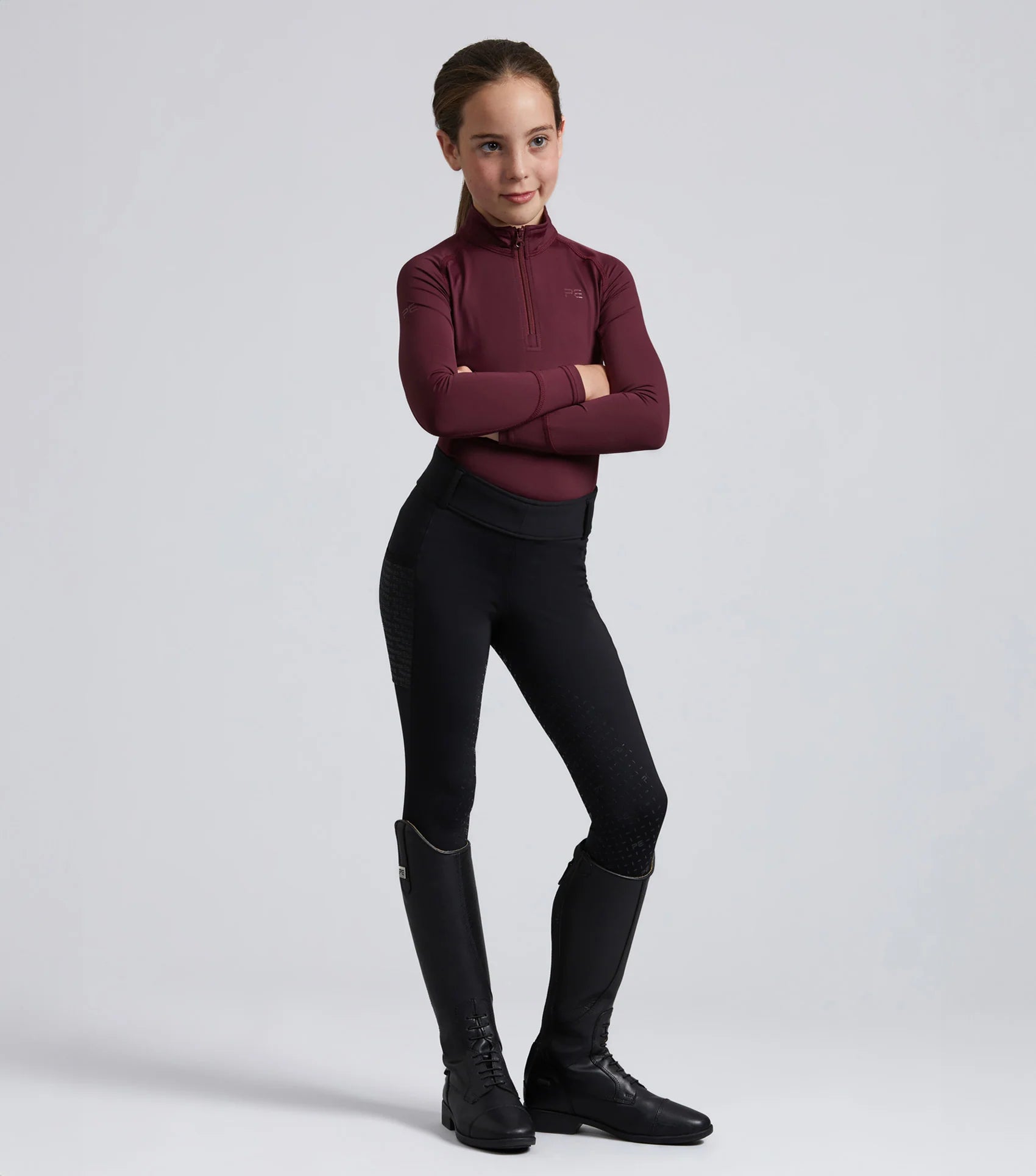 Junior Riding Top: Premier Equine Ombretta Technical Equestrian Shirt in Wine Color. Comfortable & Stylish for young riders.