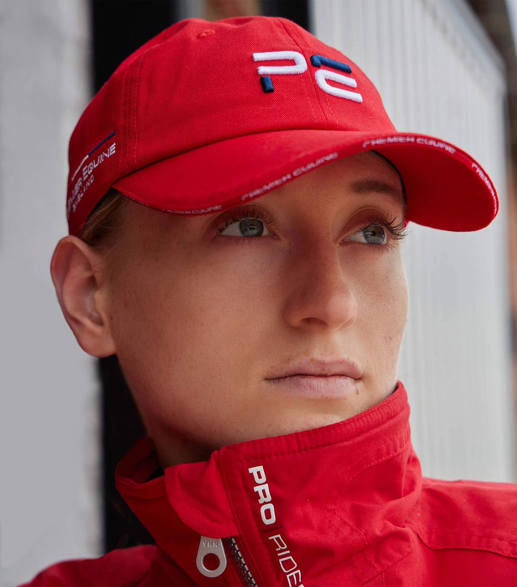 Premier Equine Baseball Cap - Red. Woman wearing PE cap from Equiflair. #PremierEquine #BaseballCap #Equiflair