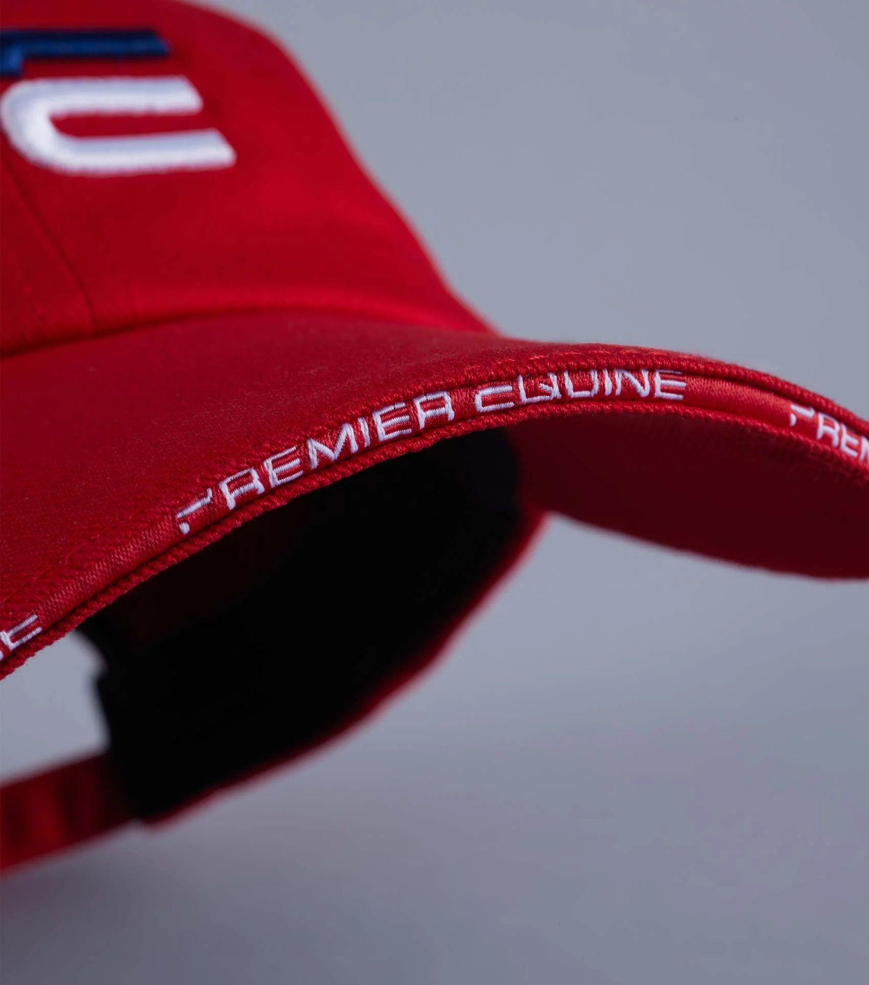 Premier Equine Red Baseball Cap: Embroidered logo, adjustable fit. Equiflair Equestrian sports apparel.