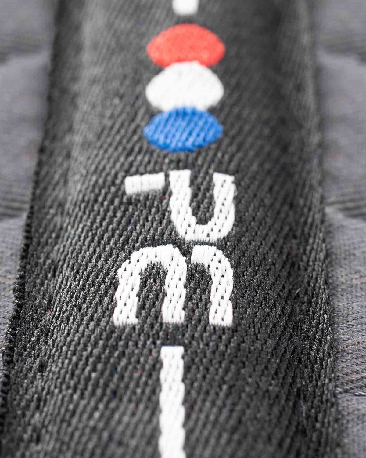 PREMIER EQUINE PONY Grey Cotton GP/Jump Square Saddle Pad - Superior Quality, Comfort, & Wicking. Red/White/Blue Accents. Close-up.