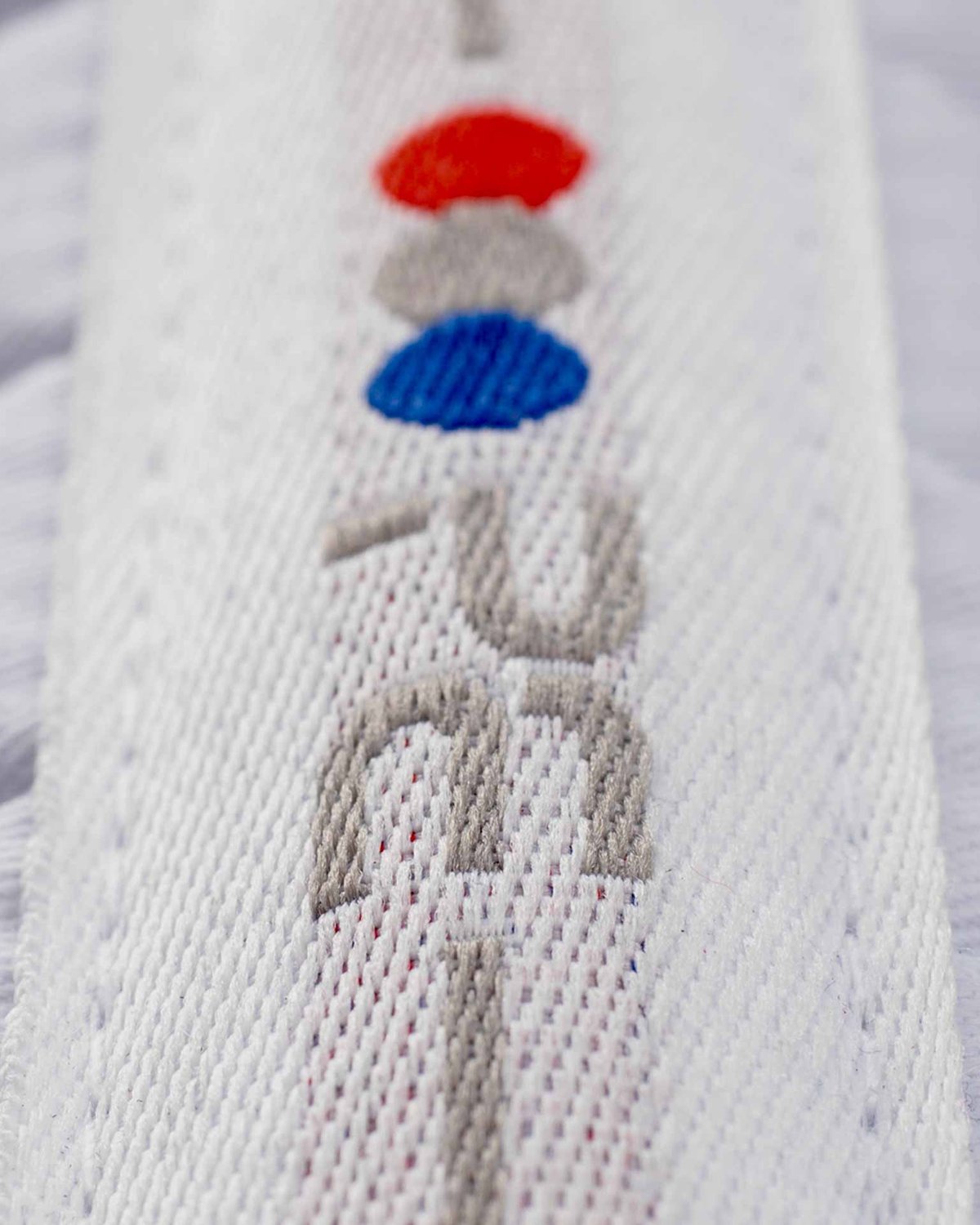 Premier Equine Pony White Dressage Square close up showing logo & fabric. Cotton saddle pad for ponies.