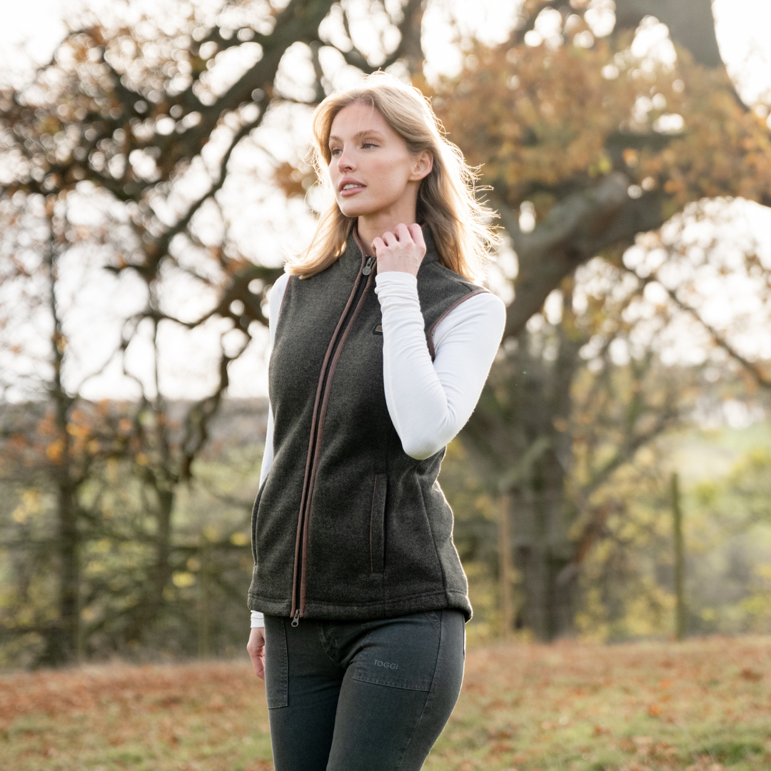 TOGGI Regent womens fleece gilet, country style zip-through with melange effect, worn by a woman outdoors.