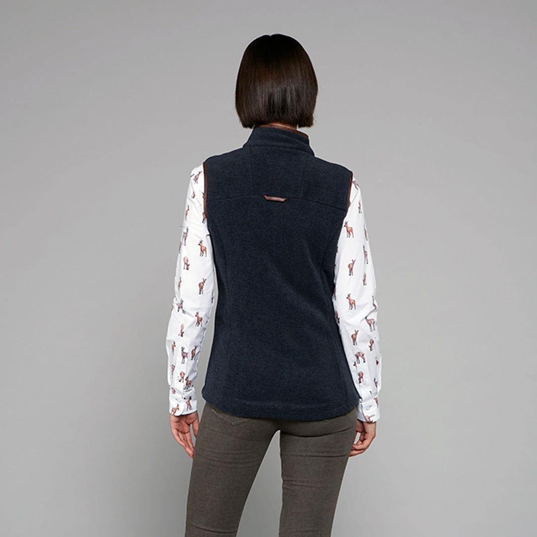 TOGGI REGENT WOMENS FLEECE GILET in navy, worn over a deer print shirt. Back view.