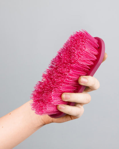 Premier Equine Soft-Touch Dandy Brush - Wine & Fuchsia. Horse Grooming Brush held in hand.