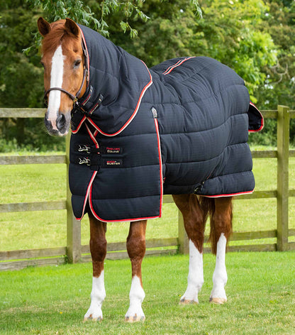Horse wearing Premier Equine Stable Buster 450g rug with neck cover, black insulated blanket.