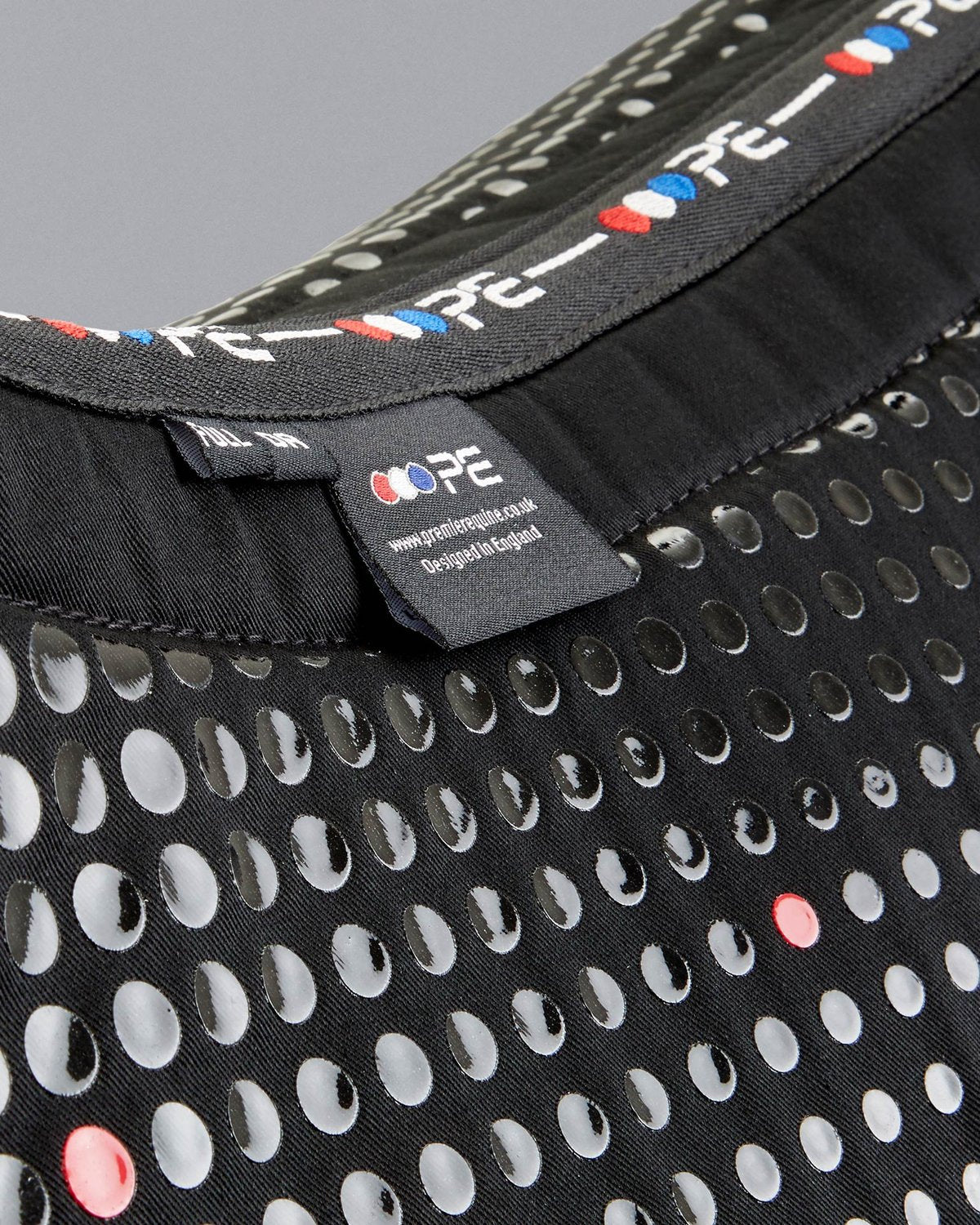 Premier Equine Dressage Saddle Pad: Anti-Slip Tech Grip Design, close-up of PE logo. Ideal saddle pad for enhanced stability.