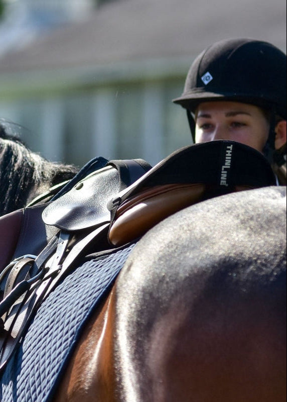 THINLINE Seat Saver Black on Saddle with Rider. Stable Riding and Improved Equitation. - Jump/Close Contact