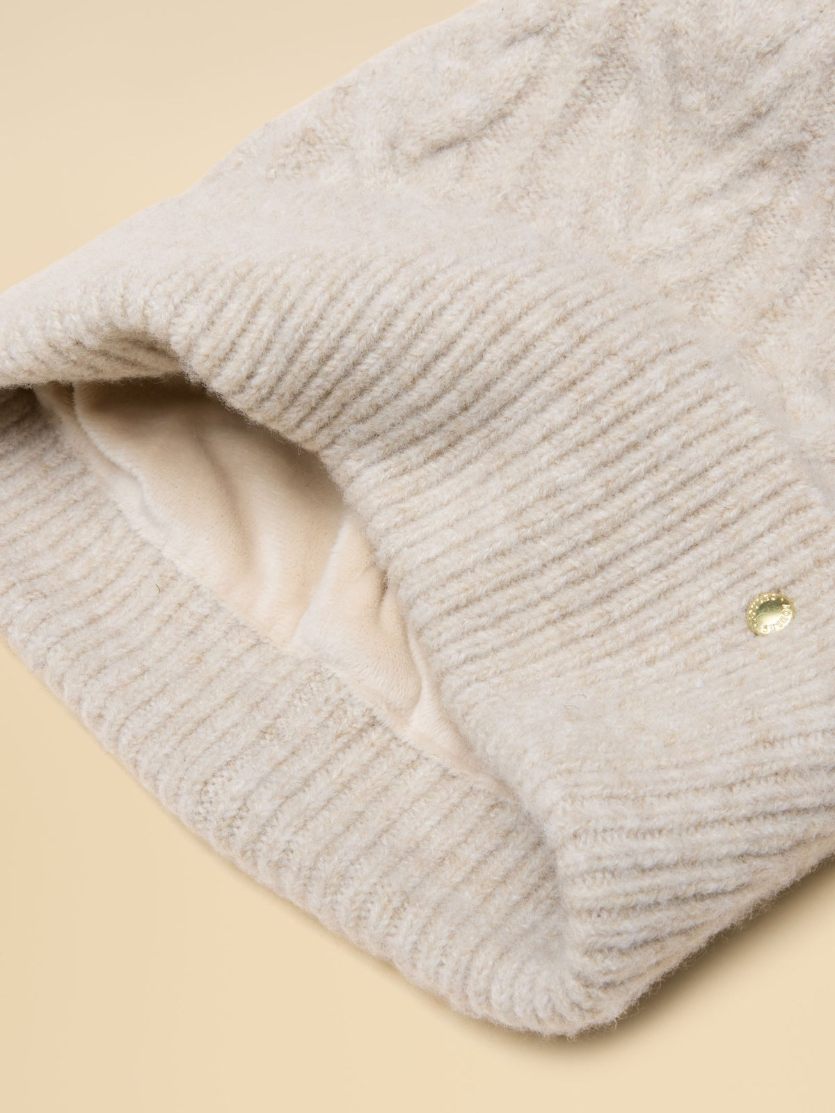 Joules women's cream cable knit winter hat with soft thermal lining and subtle gold branding tab