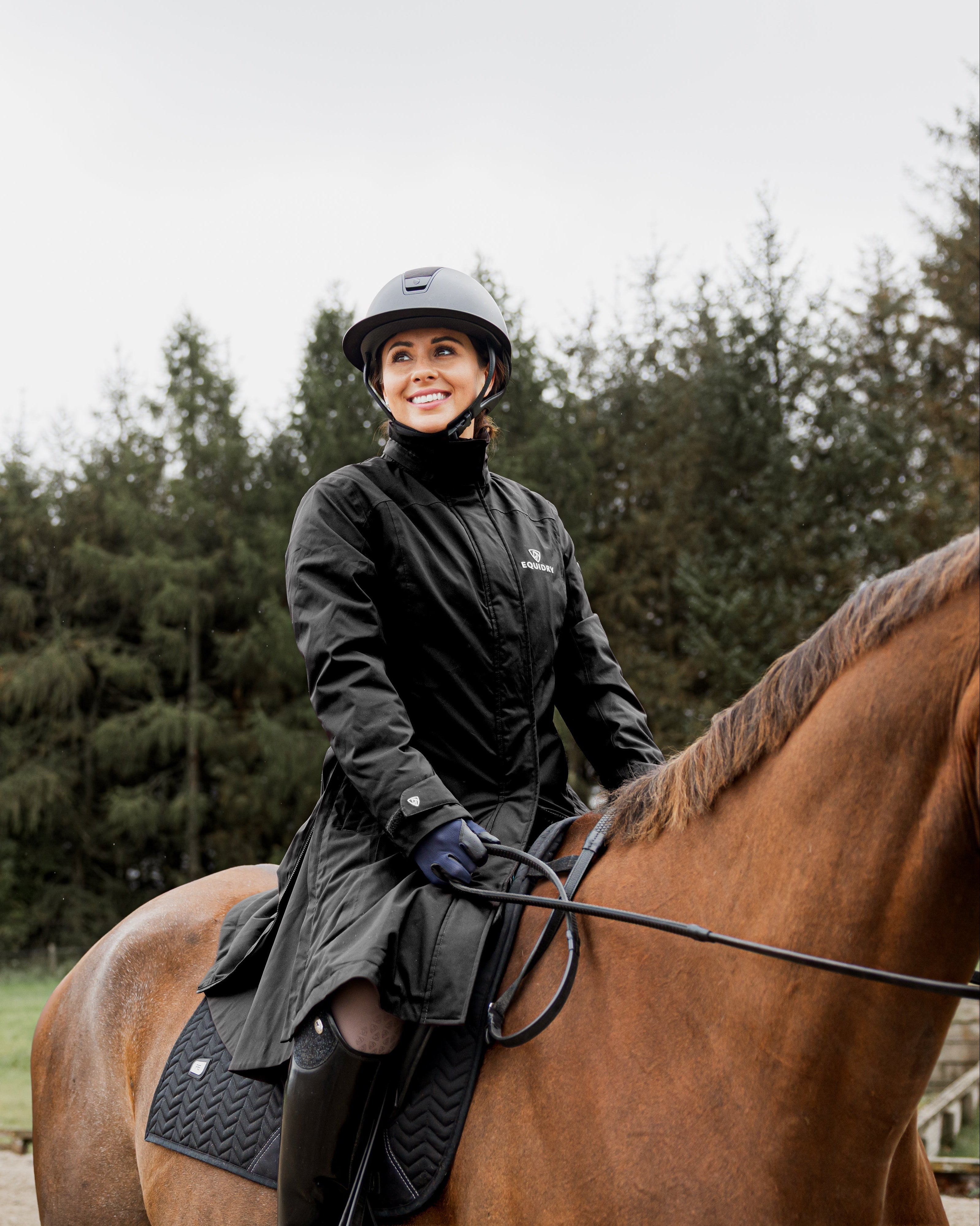 Equidry Women's Bronte Black Waterproof Riding Coat on Horseback. Equestrian Apparel.