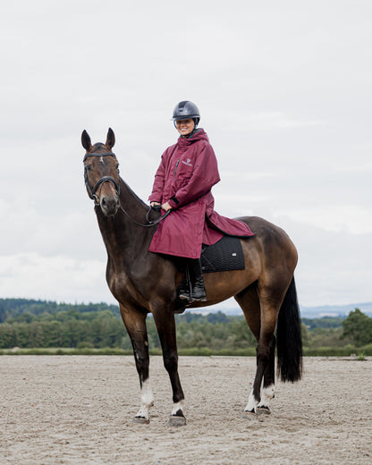 EQUIDRY Plum Horse Riding Coat: Woman in Waterproof Outerwear on Horseback