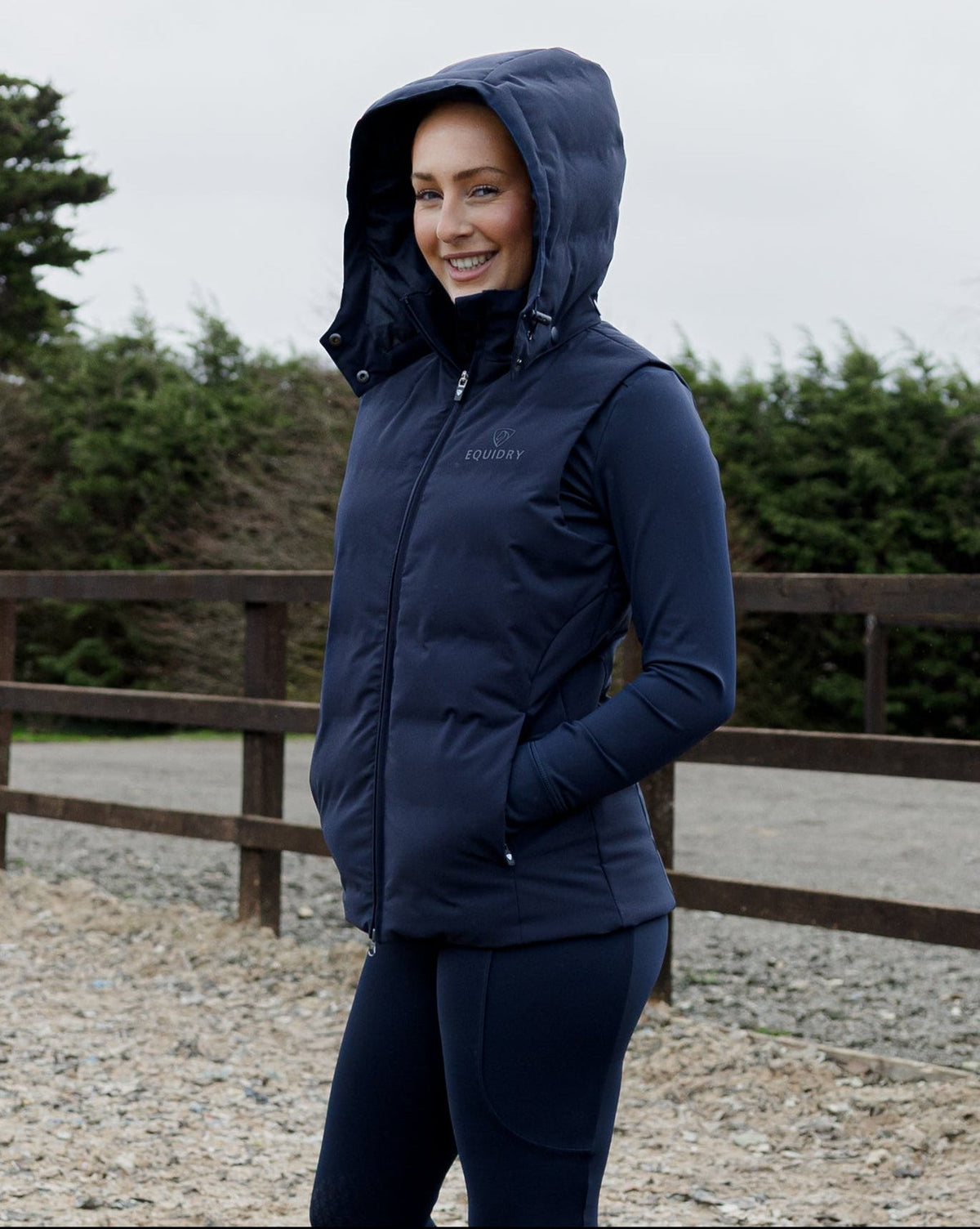 Women's EQUIDRY Torrent navy equestrian riding gilet: water-repellent, windproof, padded vest with removable hood.