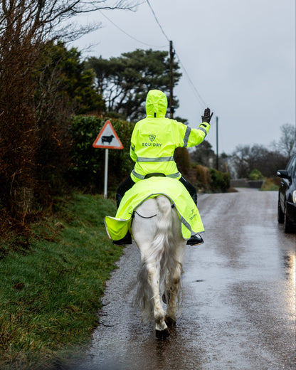 Equidry hi-vis waterproof riding coat on horseback in the rain.