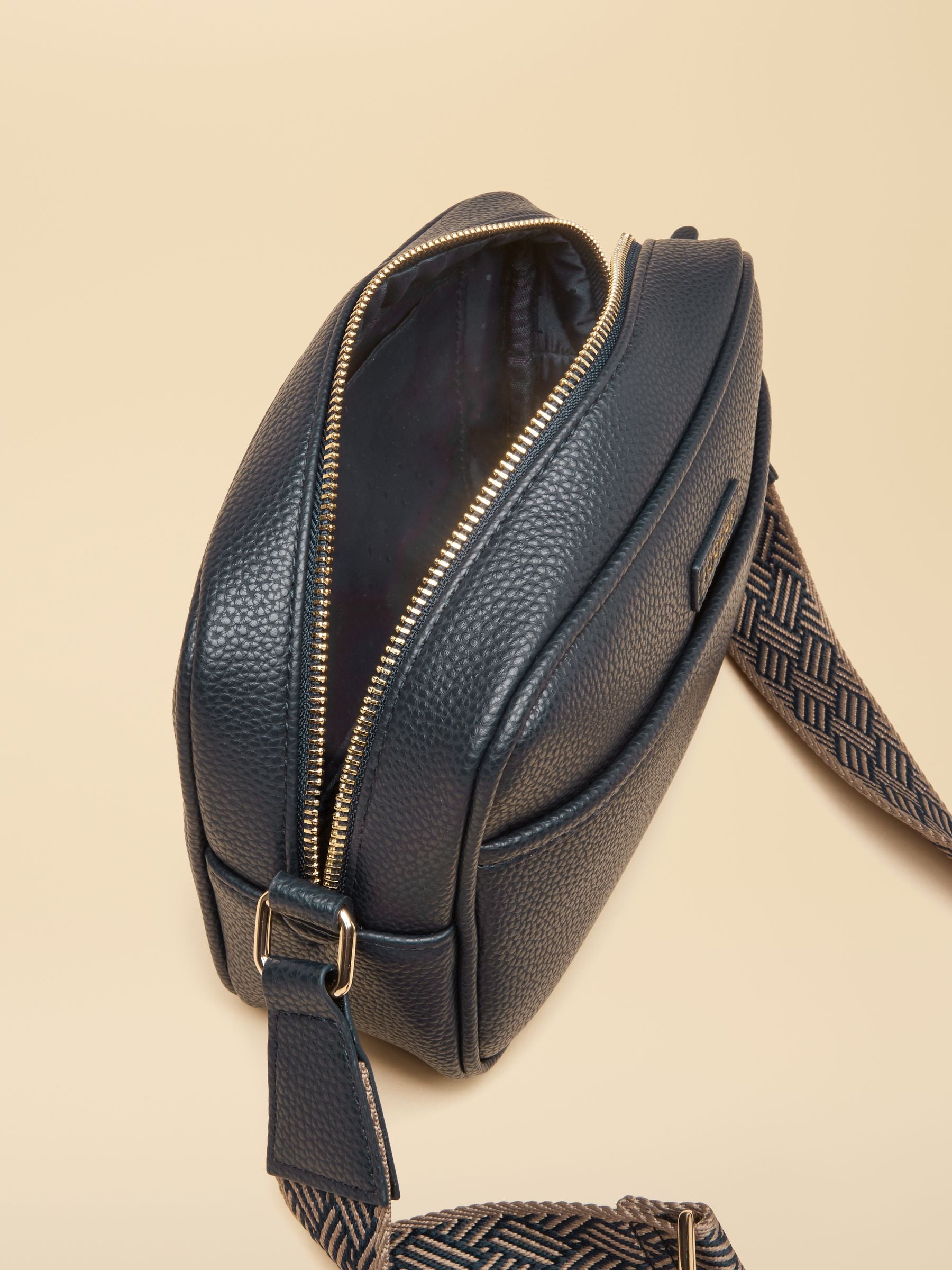 Joules Trent navy blue faux leather crossbody bag with adjustable strap and zip closure.