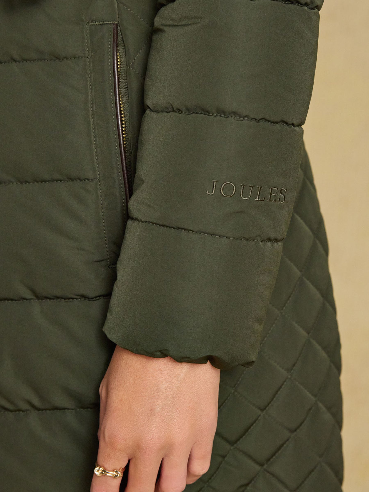 Green padded coat with Joules logo for women - showerproof outerwear with faux fur hood.