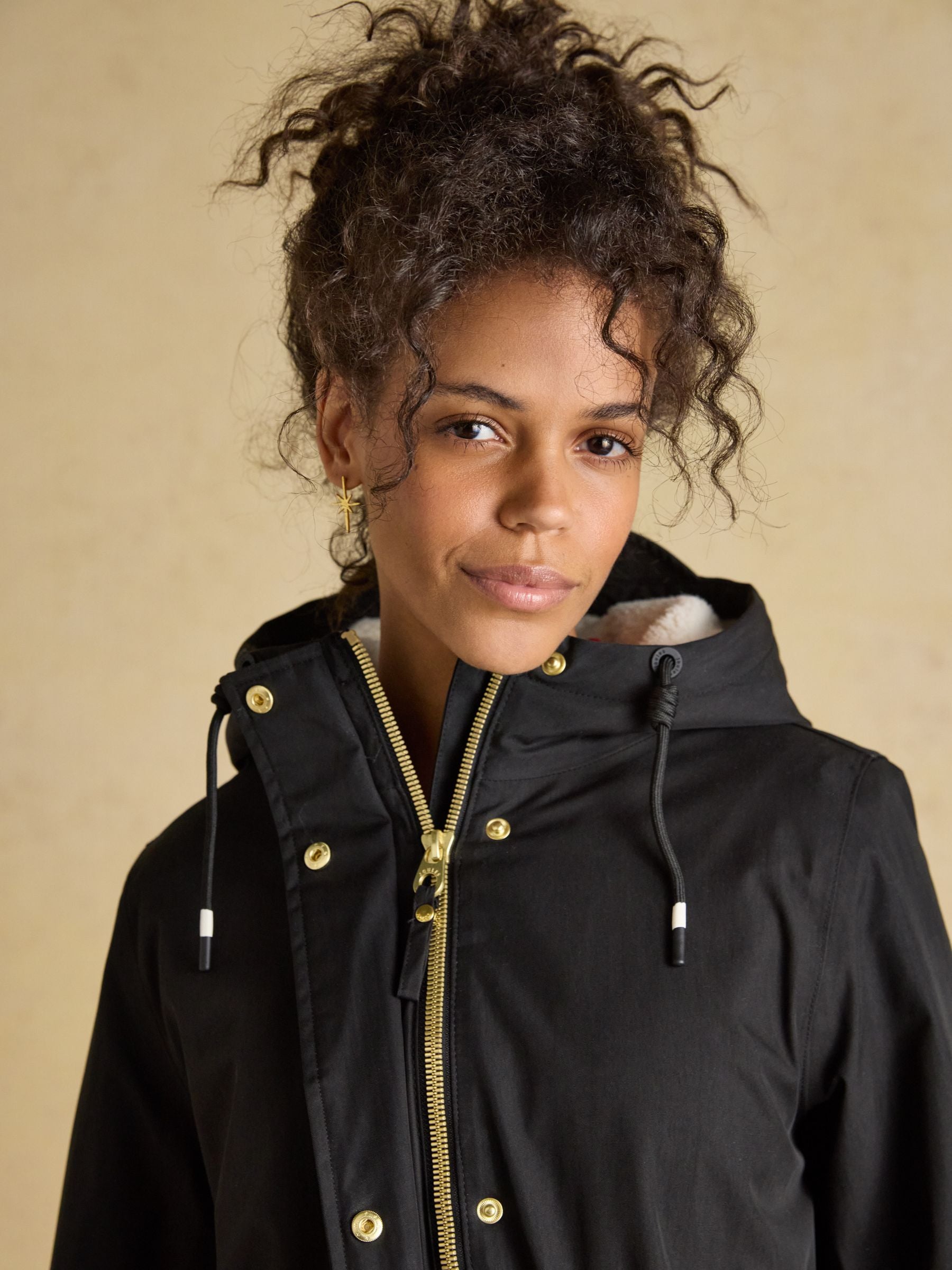 Joules women's black fleece-lined waterproof raincoat with hood - stylish and warm outerwear.