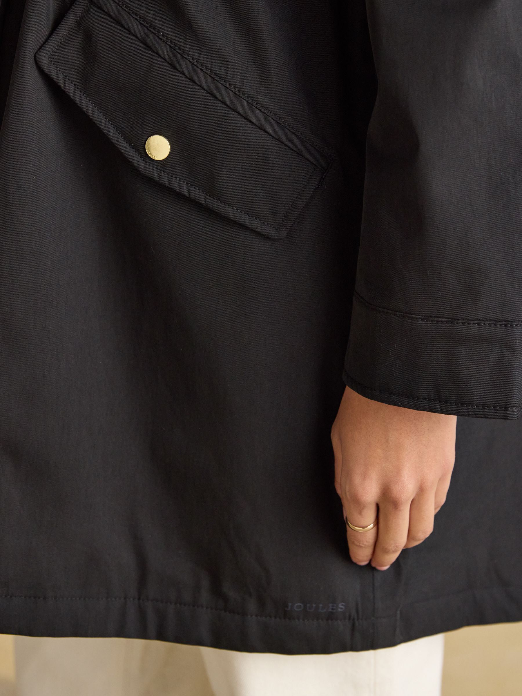 Joules women's black waterproof raincoat, fleece lined, hooded, adjustable waist, button pocket detail