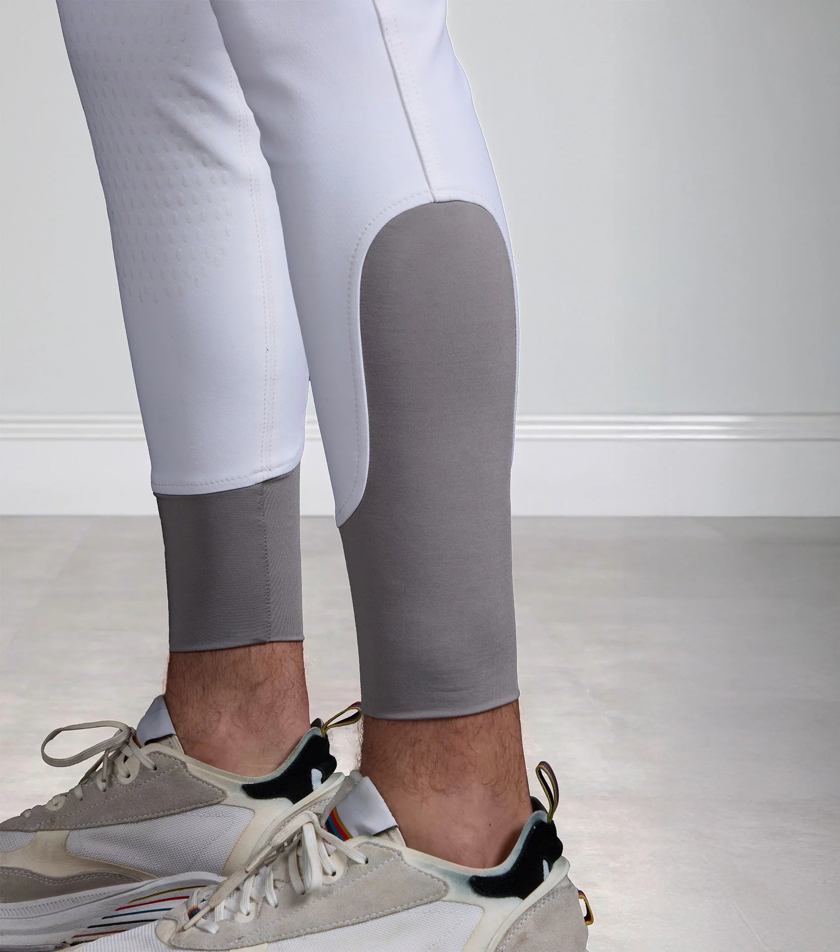 Premier Equine Men's White Gel Knee Competition Breeches: Stylish and functional riding apparel for male equestrians.