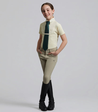 Girl in Premier Equine Brava Beige Riding Breeches with full seat gel, Equestrian Competition Apparel