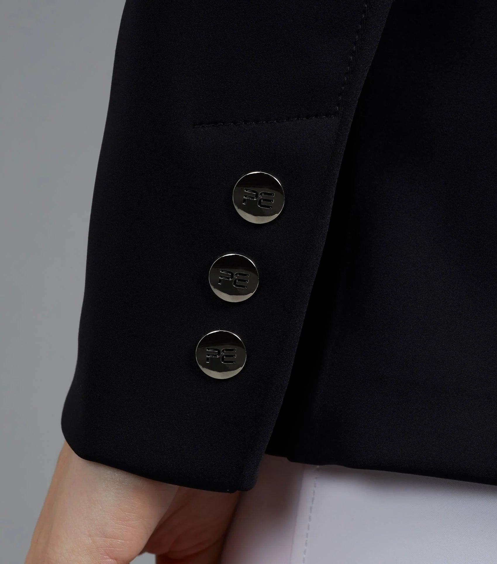Black Dressage Jacket Sleeve Detail: Stylish Buttons, Equine Elegance