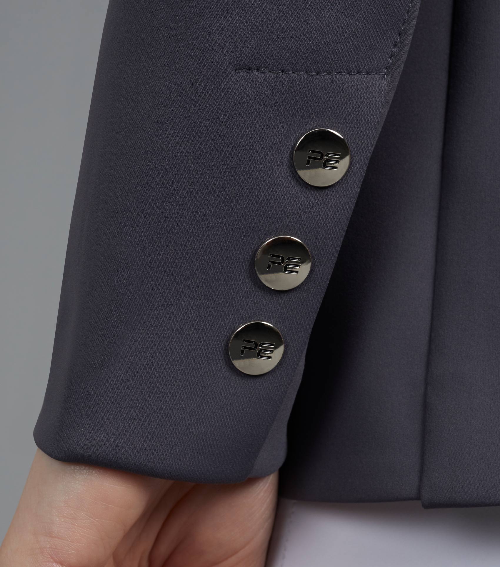 Premier Equine Capriole Ladies Short Tail Grey Dressage Jacket with branded buttons on sleeve.