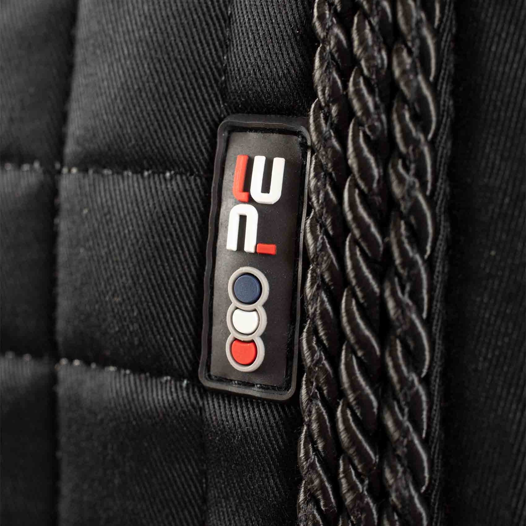 PREMIER EQUINE Close Contact Saddle Pad - Black GP/Jump Square. Twisted rope detail, brand logo close-up.