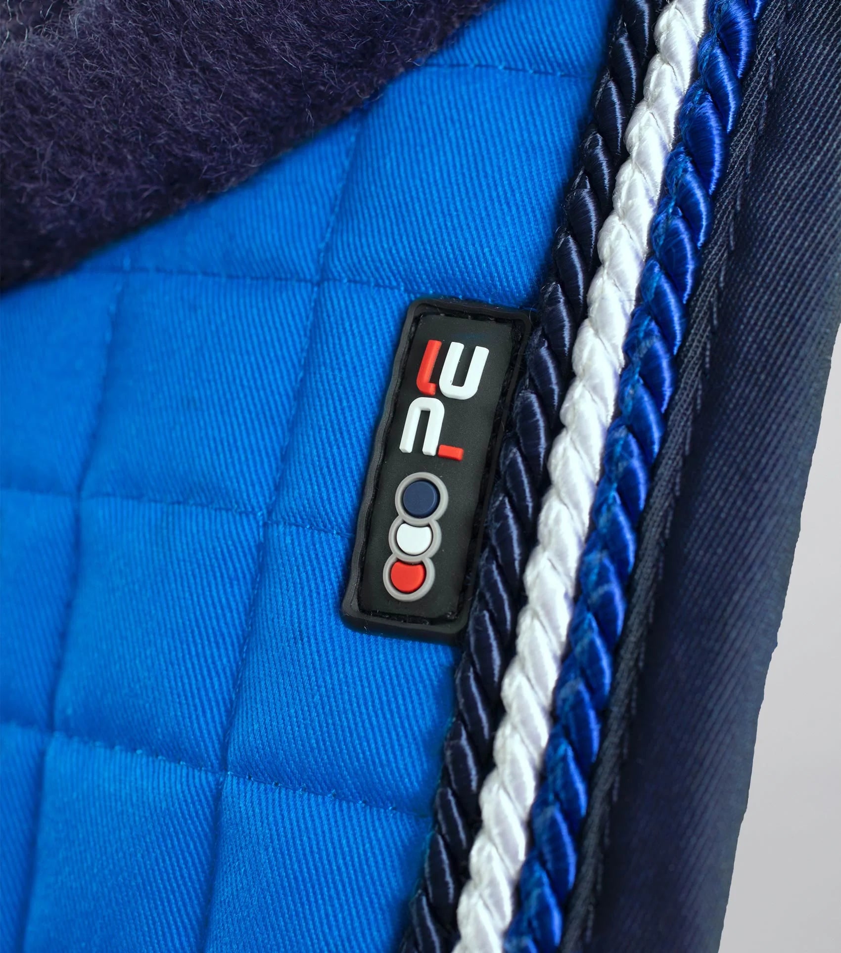 PREMIER EQUINE Dressage Saddle Pad - Royal Blue Merino Wool Close Contact Square Pad. Equestrian horse riding equipment detail.