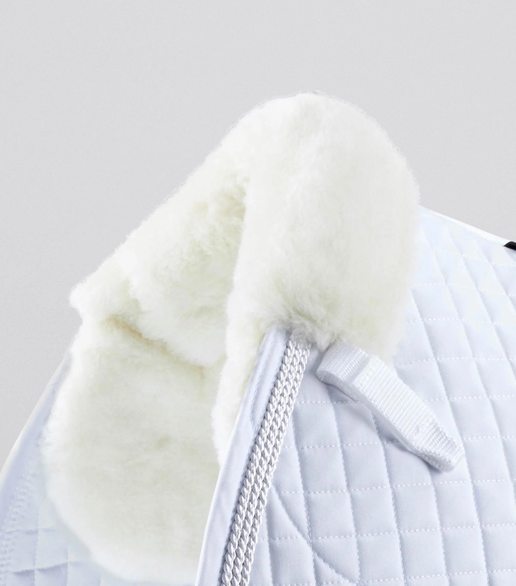 Premier Equine Merino Wool Saddle Pad: White equestrian pad with natural wool lining for horse riding comfort & performance.
