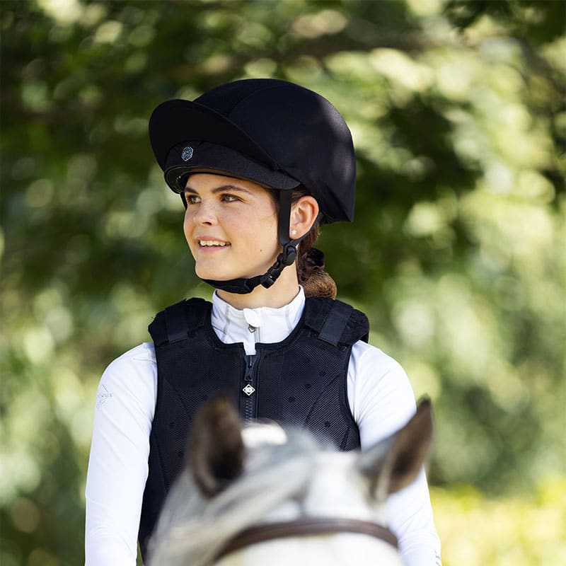 Charles Owen EQx Phoenix Skull Hat: MIPS Black Riding Helmet for Equestrian Safety. High performance, adjustable, secure riding headwear.
