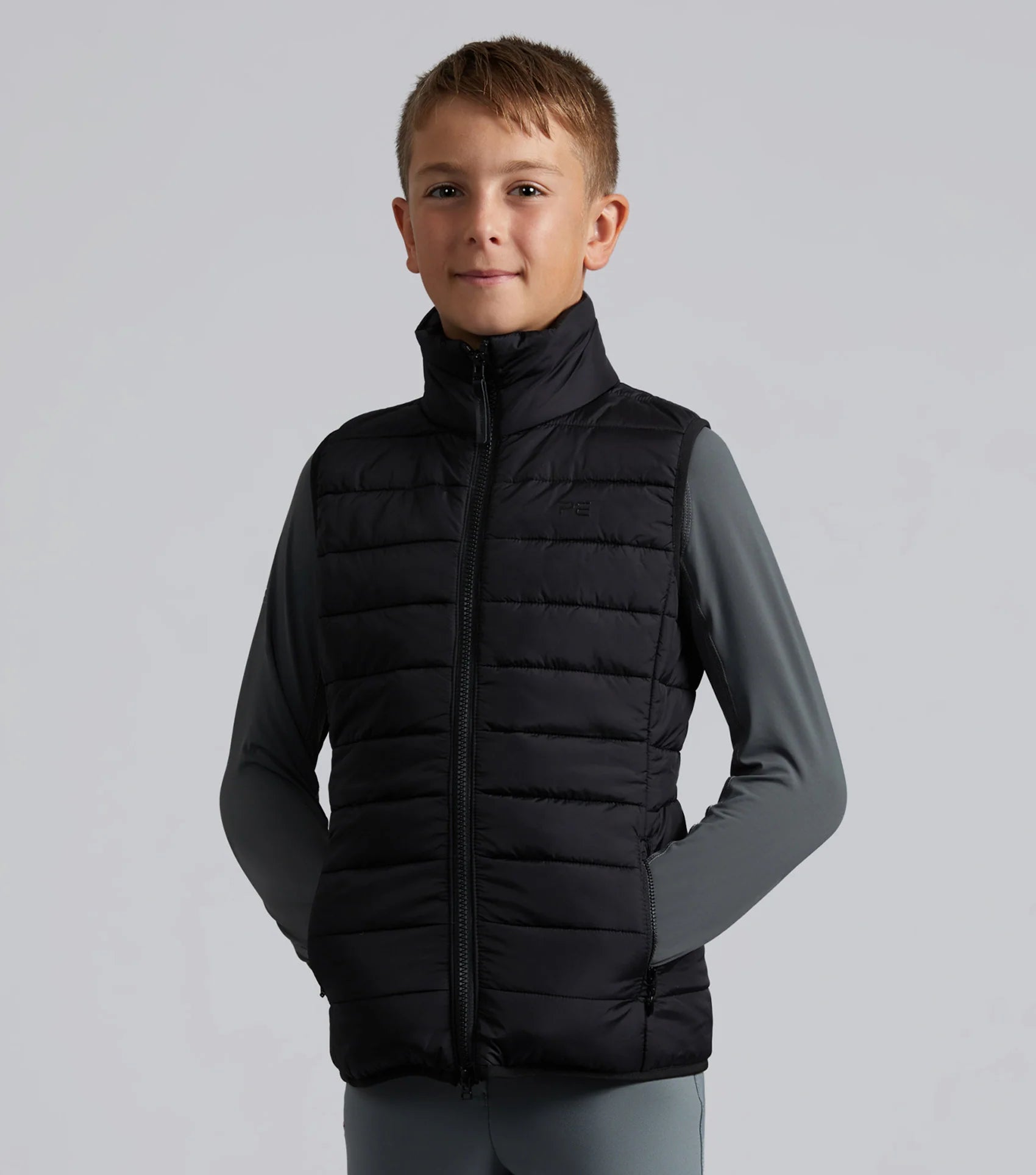 Boy wearing PREMIER EQUINE Dante Junior Riding Gilet Black. Equestrian Apparel.