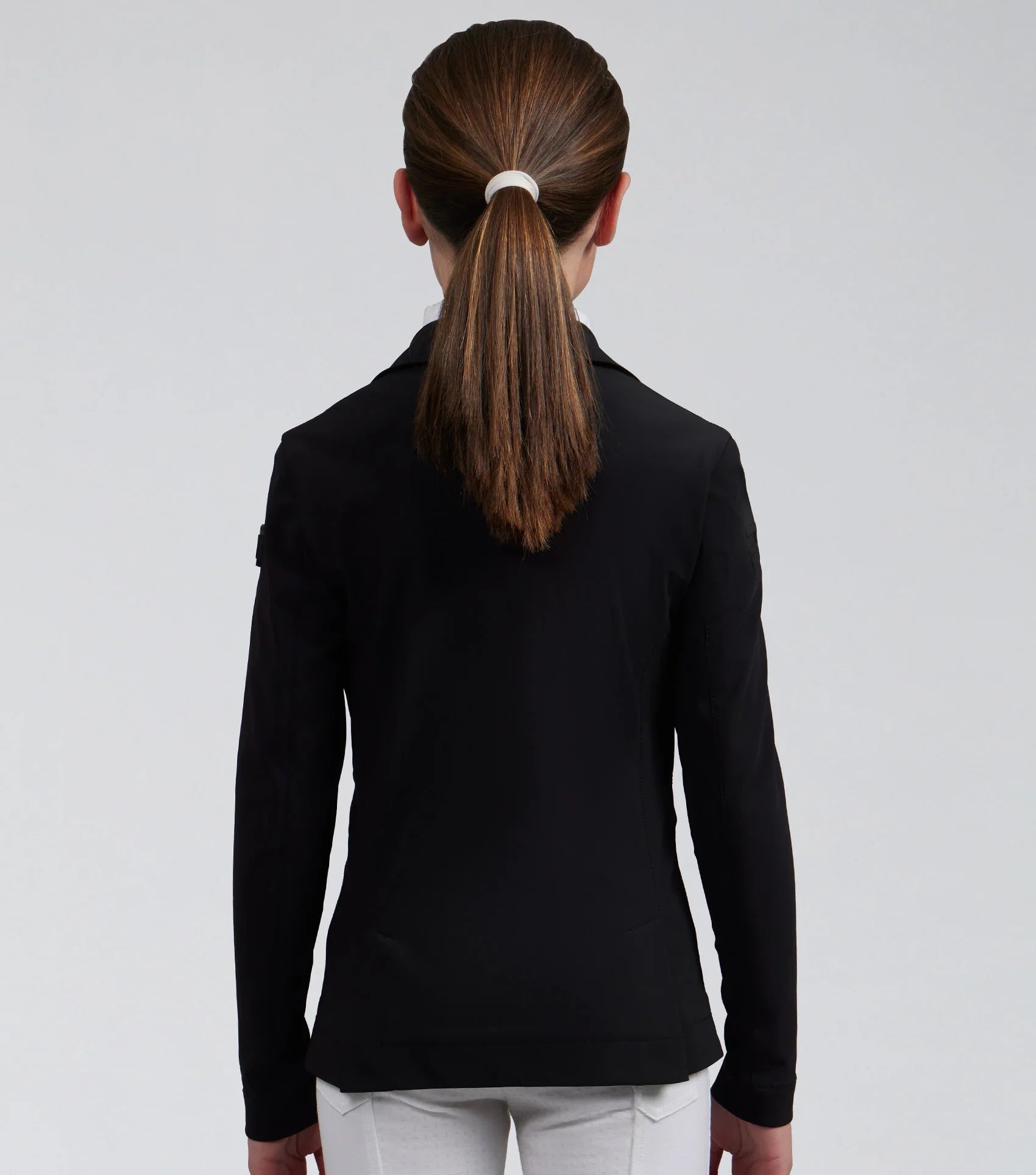 Girls equestrian competition jacket in black - back view. Riding show jacket for horseback riding competitions.