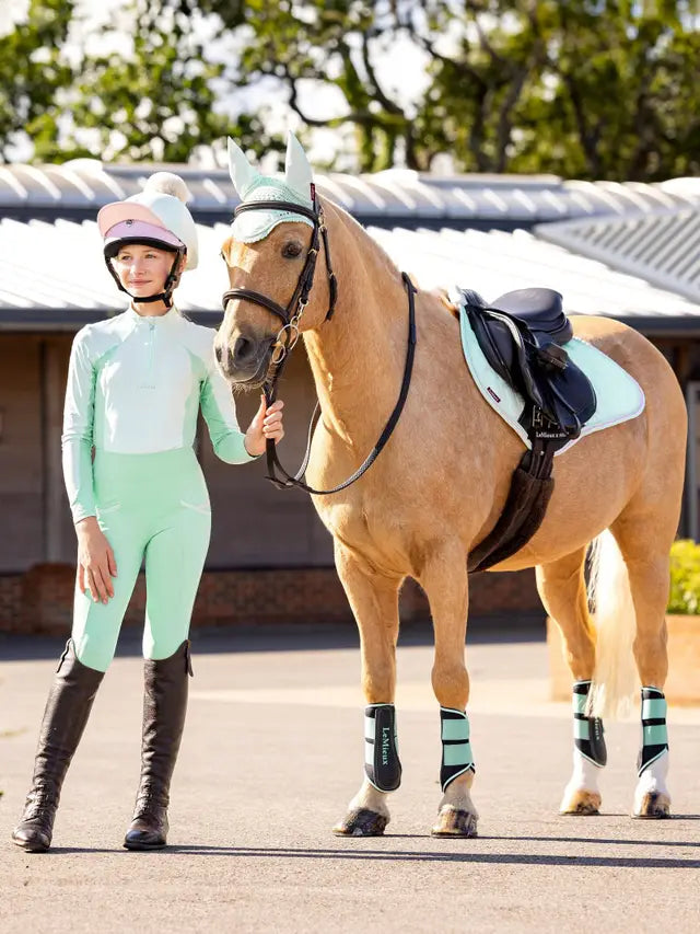 LeMieux Harlow Softmint Base Layer: Equestrian girl and matching horse gear (boots, saddle pad, fly bonnet, leg protection). Equiflair store.