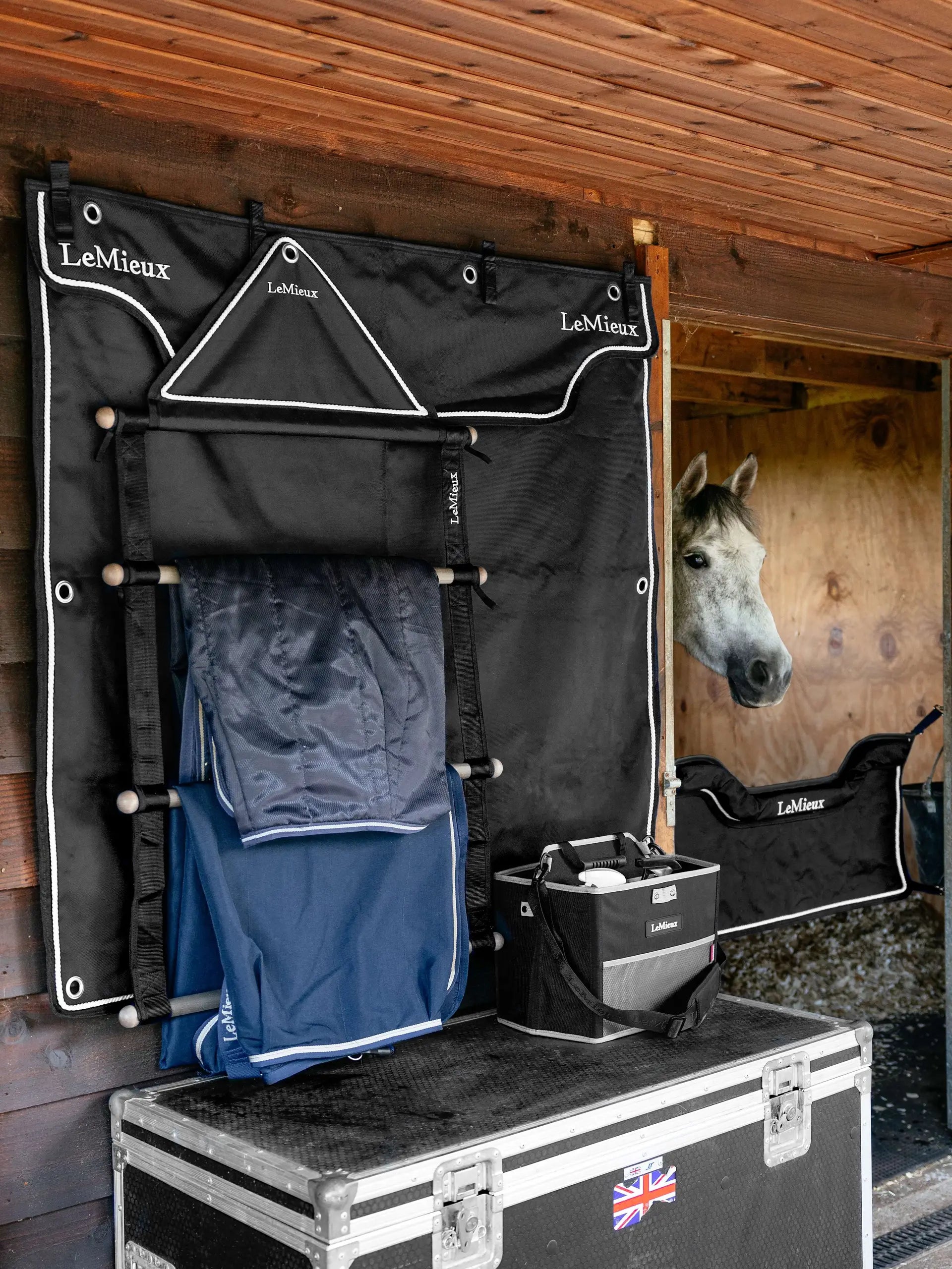 LEMIEUX Black Show Stable Drape with blankets and storage, featuring a horse in stable. Equine equipment for organization.