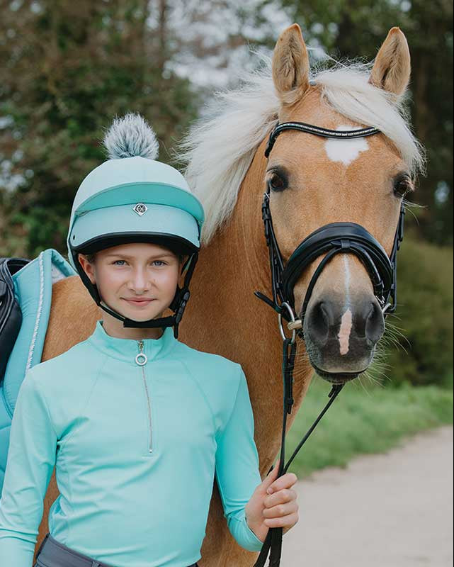 Equestrian girl & palomino horse in mint Charles Owen JS1 Pro helmet. Horse riding gear.