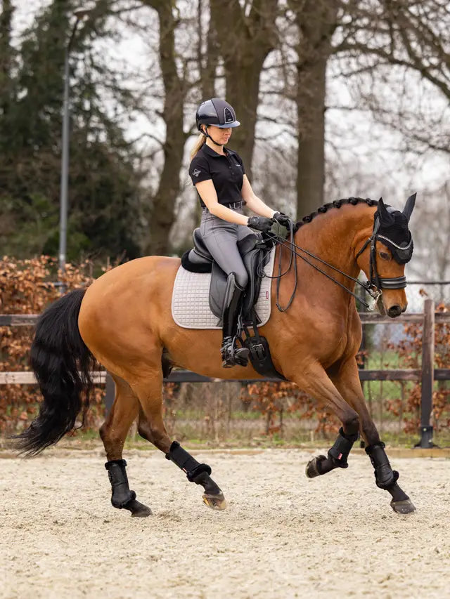 LeMieux Cotton Dressage Square Saddle Pad - Grey: Equestrian riding with horse in dressage gear.