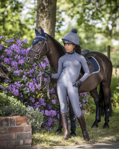 Young rider in LEMIEUX breeches with horse. Youth equestrian apparel.