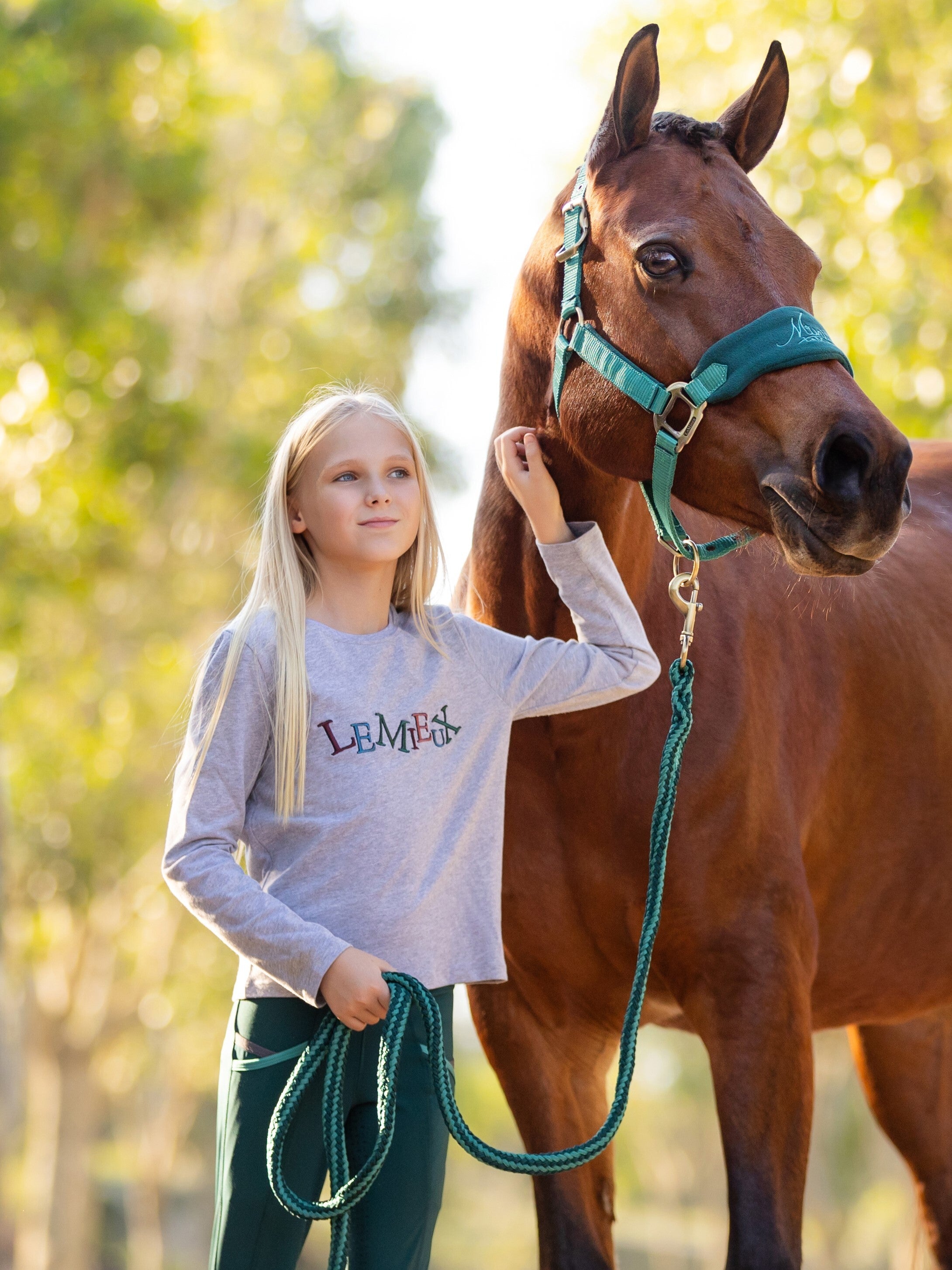 Girl with horse wearing Lemieux Mini Jamie Long Sleeve Top Grey: Children's Equestrian Fashion